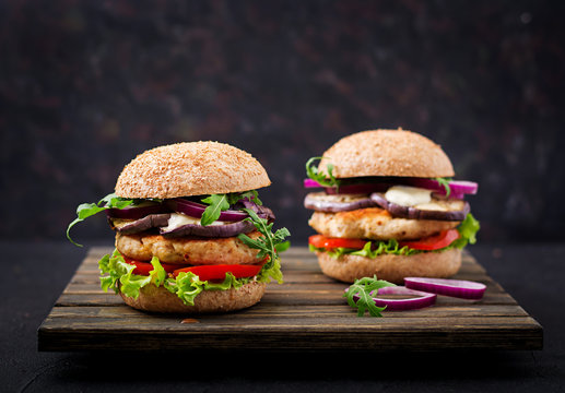 Sandwich juicy spicy chicken burgers with tomato and eggplant