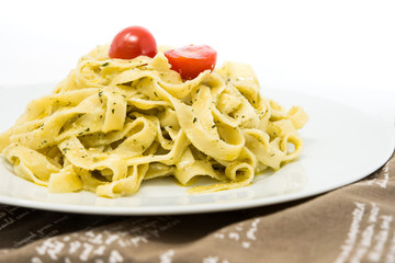 Pasta with pesto sauce and nuts on a the table