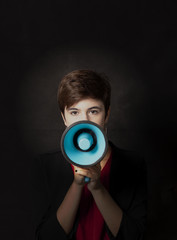 Fototapeta premium girl with megaphone on dark background