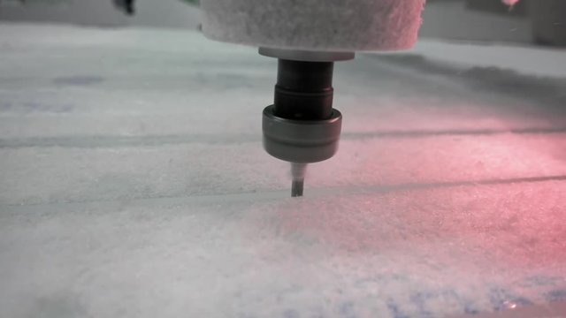 Milling cutter cuts plastic part on robotized production line. Factory robots used to produce precise an strict product on automation conveyor lines.