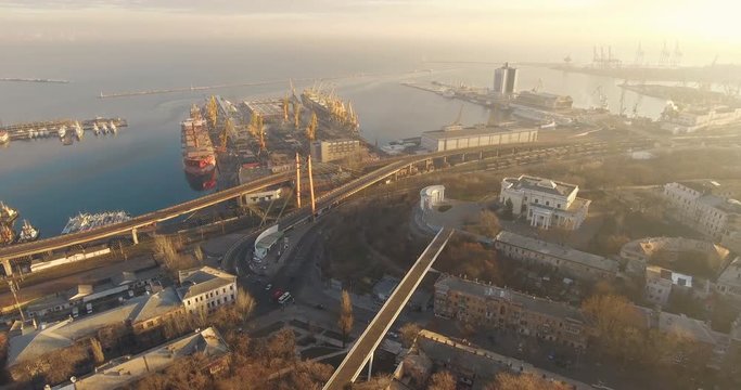 Beautiful aerial footage of the Odessa city, at sunset time, drone view, black sea and port, Ukraine 