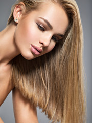 Naklejka premium Beautiful young woman with long straight hairs