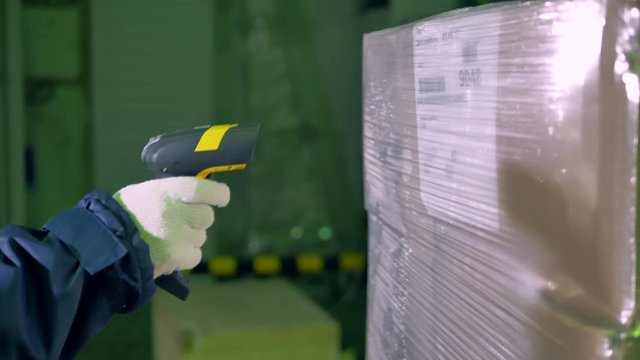 Bar Code Scanner. Worker use bar code scanner for checking goods at a warehouse. 4K.