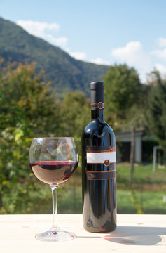Red wine bottle with wineglass