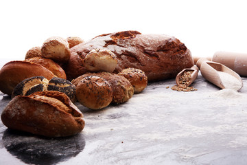 Different kinds of bread and bread rolls on black board. Kitchen or bakery poster design