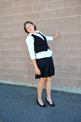 Female nanny in uniform taking a break outside.