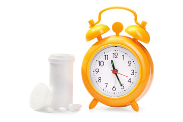 Orange alarm clock and medical pills