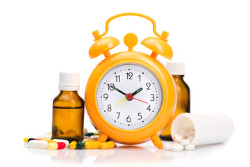 Orange alarm clock and medical pills