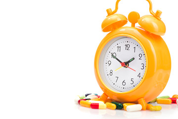 Orange alarm clock and medical pills