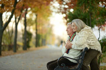 Couple sitting on wooden bench © aletia2011