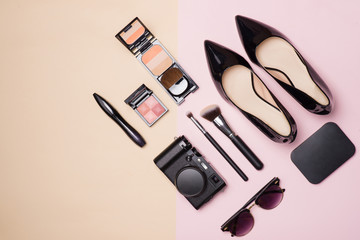 A collection of make up cosmetic beauty with camera and shoes on light color background