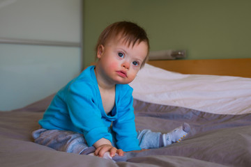 Fototapeta premium Portrait of cute baby boy with Down syndrome
