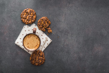Hot coffee cup with chocolate cookies on stone