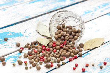 Spices are scattered on an old table.