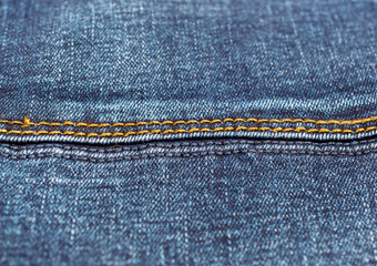 Stitches on blue jeans. Close up.
