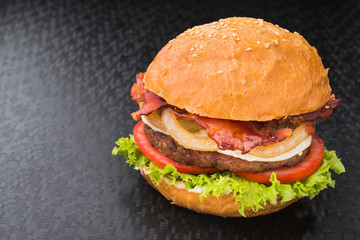 Juicy and big hamburger with bacon