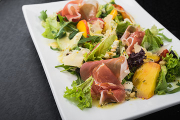 tasty salad with prosciutto