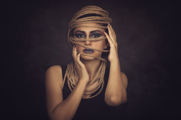 Attractive woman portrait with rope