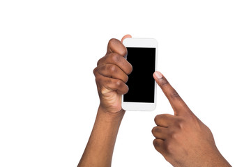 Black hand holding mobile phone on isolated white background.