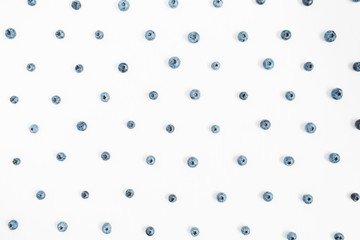 Blueberries on white background. Food blog or magazine concept texture.