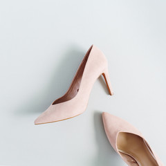 Fashion blog look. Pale pink women high heel shoes on blue background. Flat lay, top view trendy beauty female background.