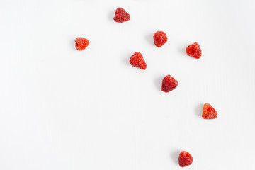 Raspberries on white background. Food blog or magazine concept texture.