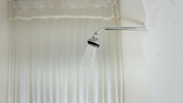 Water running from a rain shower in a bathroom, a classic timeless creepy horror film scene.
