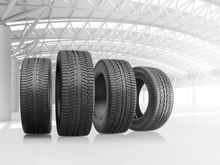 Set of four car tires at big warehouse. © iaremenko