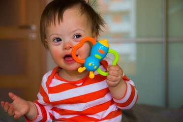 Portrait of cute baby boy with Down syndrome