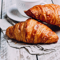 freshly baked croissants on wooden cutting board, top view