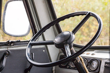 The steering wheel in the cockpit of an old car. Retro style