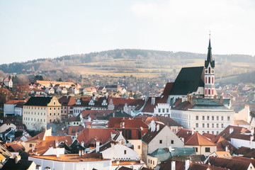 Obraz premium City view of the houses and the Church of St. Vitus in Cesky Krumlov in the Czech Republic. The church is one of the main sights of the town.