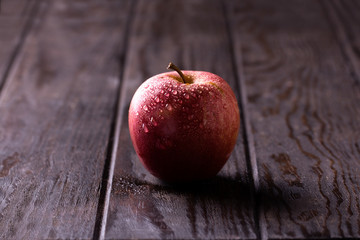 Red apple on wooden table