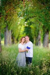 Fototapeta premium two lovers walk in the park at sunset, tenderly and dream