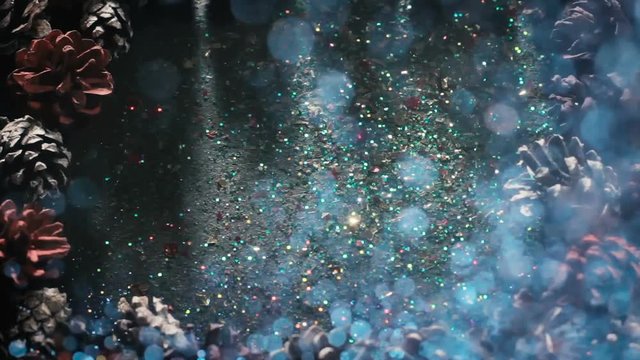 Festive Christmas glittering background, top view. Sparkles pouring out from above, free space