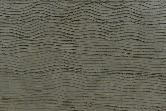Rendered cement plaster, U.K.  Freshly scratch coated wall by a plasterer.