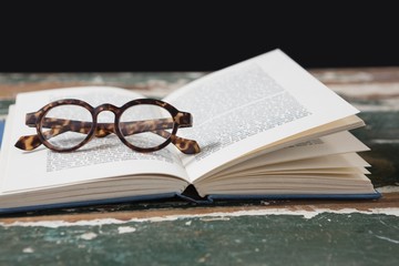Spectacles on open book