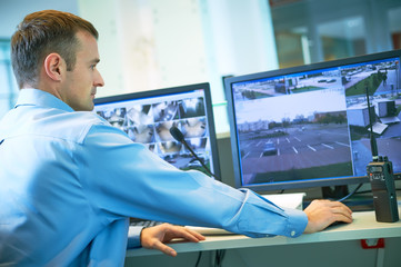 Security worker during monitoring. Video surveillance system.