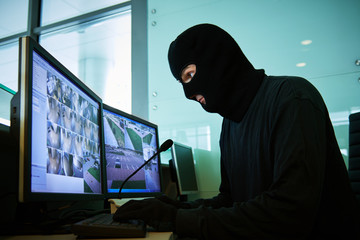 robber near surveillance video monitoring system coordinating robbery