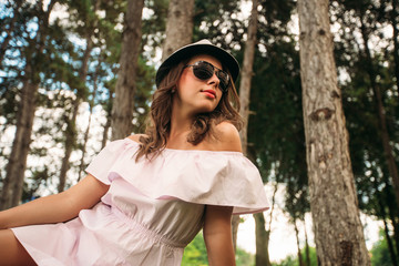 Naklejka premium Beautiful girl in the park. Green grass and sunny weather