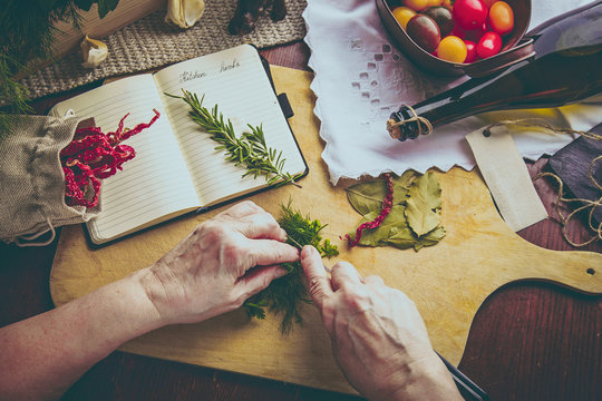 Old woman hands cutting herbs