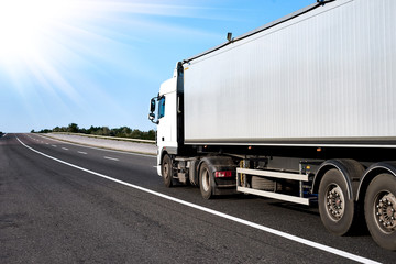 Truck on road with grey container, cargo transportation concept
