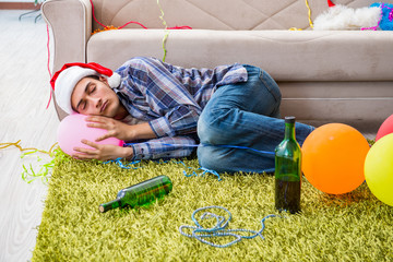 Naklejka premium Man having hangover after christmas party