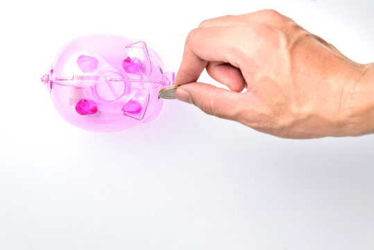 Hand Drop A Coin In Pinnk Piggy Bank on white background for money saving concept
