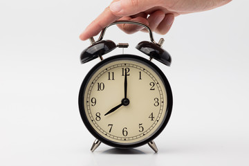 hand lies on the alarm clock