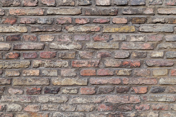 Close-up of an old and aged red brick wall texture background.