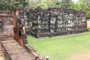 Ruins and walls of an ancient city in Angkor complex, near the ancient capital of Cambodia - Siem...