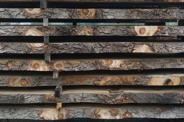 Sawn logs stacked in a pile at the sawmill