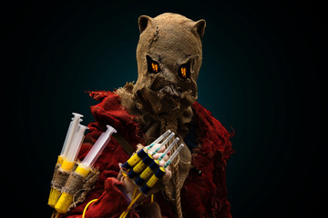 an evil scarecrow demon, syringes in his hand. cosplay