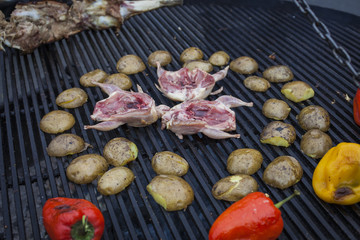 Grilling delicious poultry quails on barbecue
